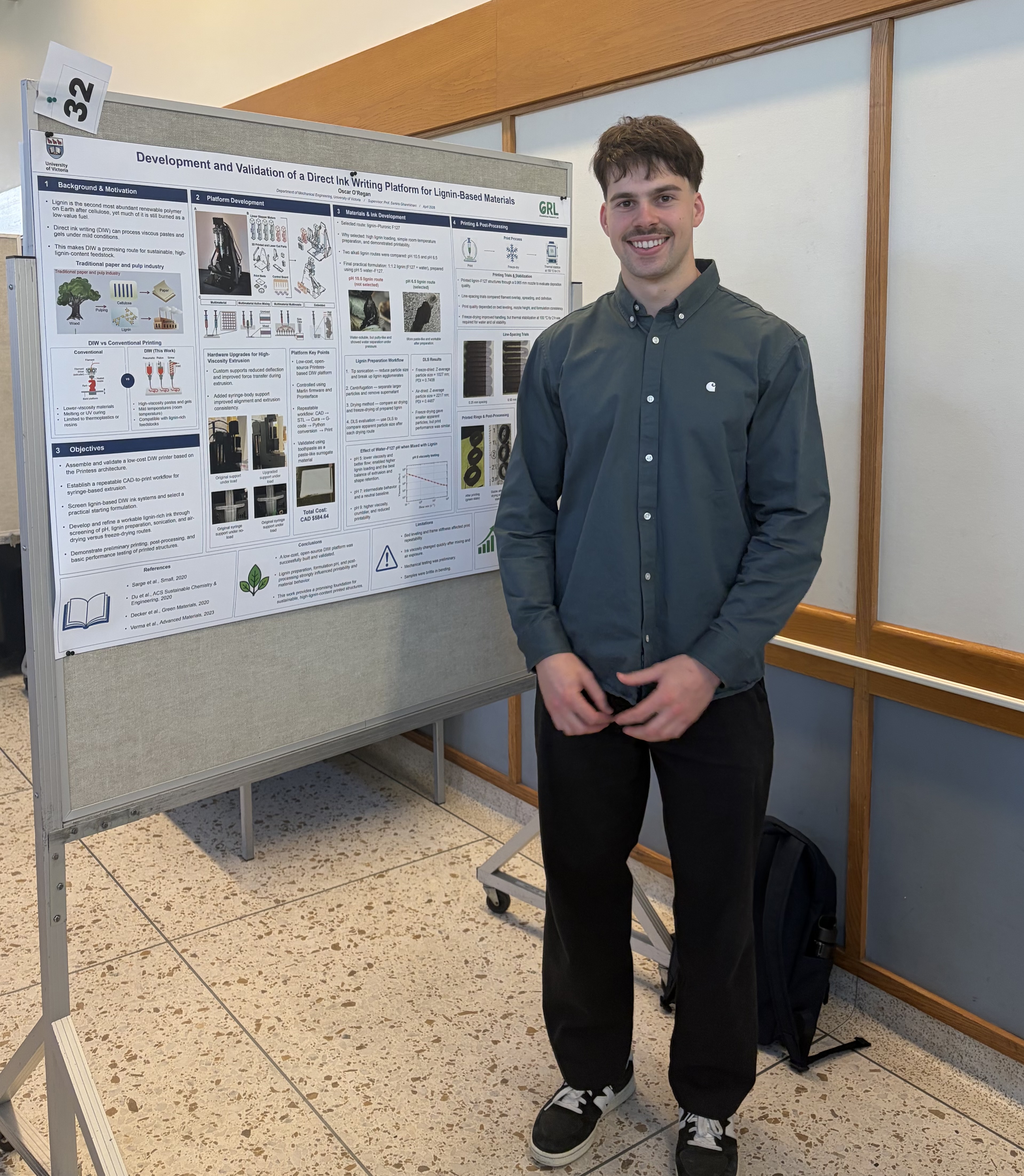 Oscar O'Regan standing with thesis poster at CAMTEC